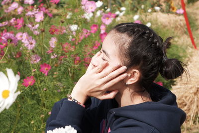 Close-up portrait of woman with pink flower