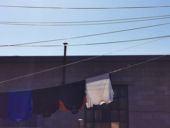 Low angle view of clothes hanging against building