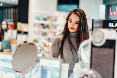 Portrait of smiling young woman in store