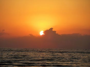 Scenic view of sea against orange sky