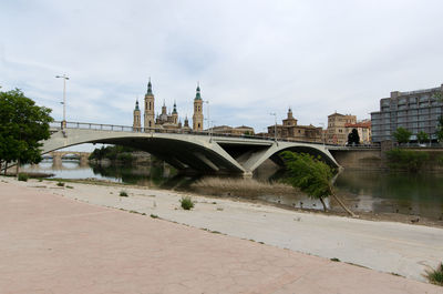 Arch bridge over river in city