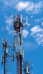 Telecommunication tower with blue sky and white clouds background. antenna on blue sky. 