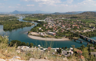 High angle view of river and cityscape against sky