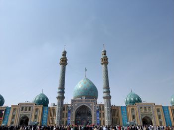 Group of people in front of building against sky