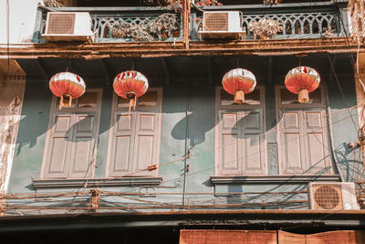 Low angle view of lanterns hanging outside building