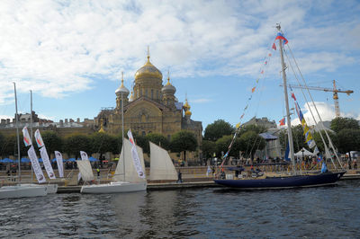 Sailboats in temple against cloudy sky