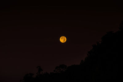 Scenic view of moon against clear sky at night