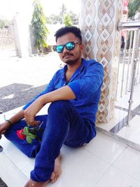 Portrait of young man sitting outdoors