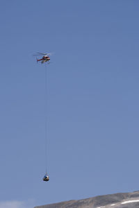 Low angle view of rescue helicopter against sky