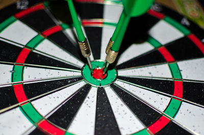 Close-up of green darts on target