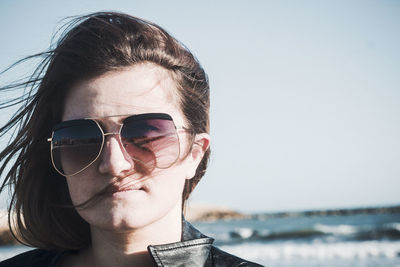 Close-up of young woman wearing sunglasses on sunny day