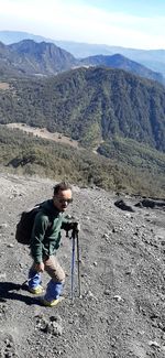 Full length of senior man photographing mountains