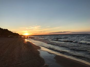 Scenic view of beach against sky during sunset