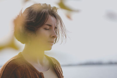 Close-up portrait of young woman looking away