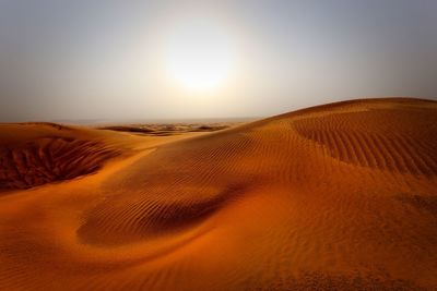 Scenic view of desert against sky during sunset