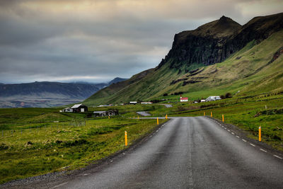 Road amidst mountains against sky