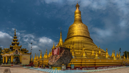 Low angle view of temple against cloudy sky
