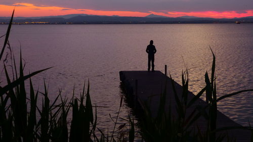 Scenic view of lake at sunset