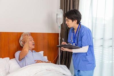 Female doctor examining patient in hospital