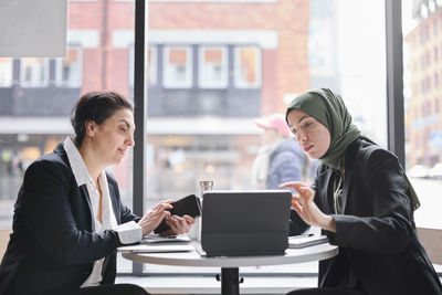 Two businesswomen sitting in cafe