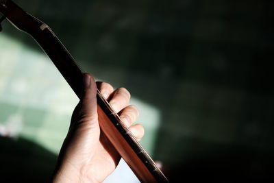 Close-up of hand playing guitar