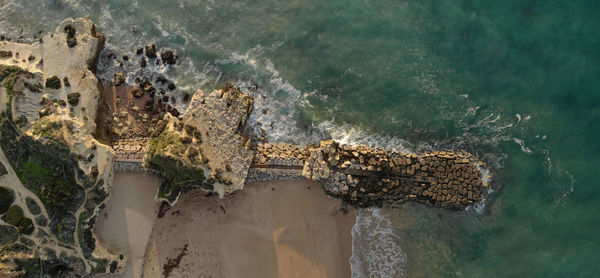 High angle view of rock formation in sea