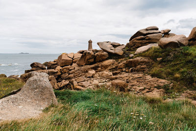Ploumanac'h lighthouse against sky. rocky coast landscape
