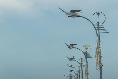 Low angle view of seagulls flying against sky