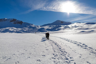 People skiing on snowcapped mountain