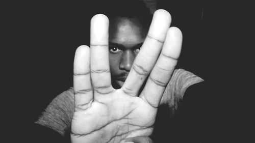 Close-up of human hand against black background