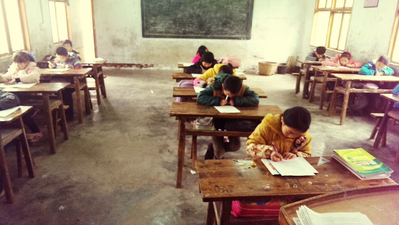 sitting, men, lifestyles, full length, leisure activity, casual clothing, togetherness, working, boys, chair, childhood, built structure, rear view, person, architecture, indoors, occupation