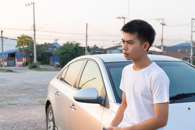 Side view of young man in car