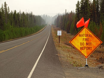 Road sign against sky