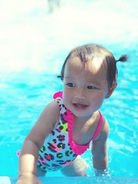 Portrait of cute boy swimming in pool
