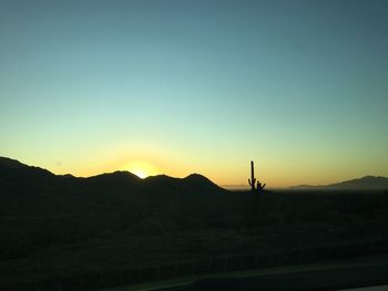 Scenic view of silhouette landscape against clear sky during sunset