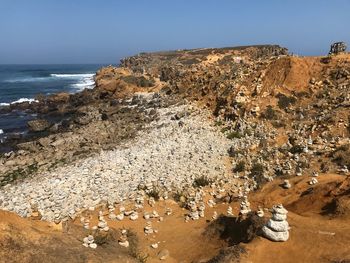 High angle view of rocks on beach against sky