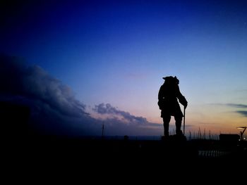 Silhouette man against sky at sunset