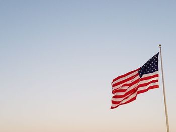 Low angle view of american flag against clear sky