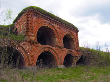 Old ruin on field against sky