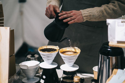 Midsection of man having coffee