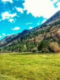 Scenic view of field and mountains against sky