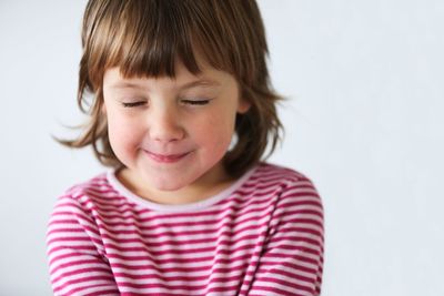 Close-up portrait of a girl over white background