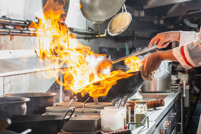 People working on barbecue grill