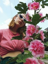 Woman on pink flowering plants