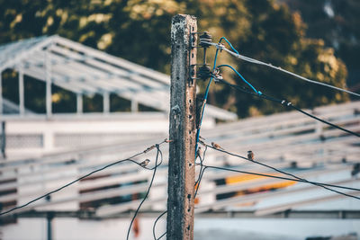 Close-up of barbed wire on fence against blurred background