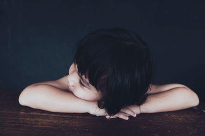 Rear view of woman sitting at home