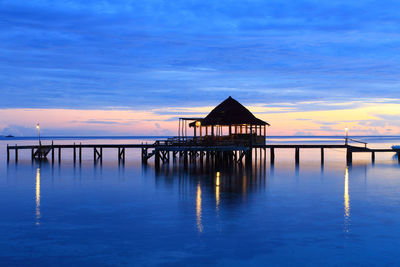 Silhouette of pier over the sea in ora beach resort, seram island, central maluku, indonesia