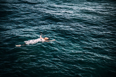 Woman swimming in sea