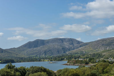Scenic view of lake and mountains against sky