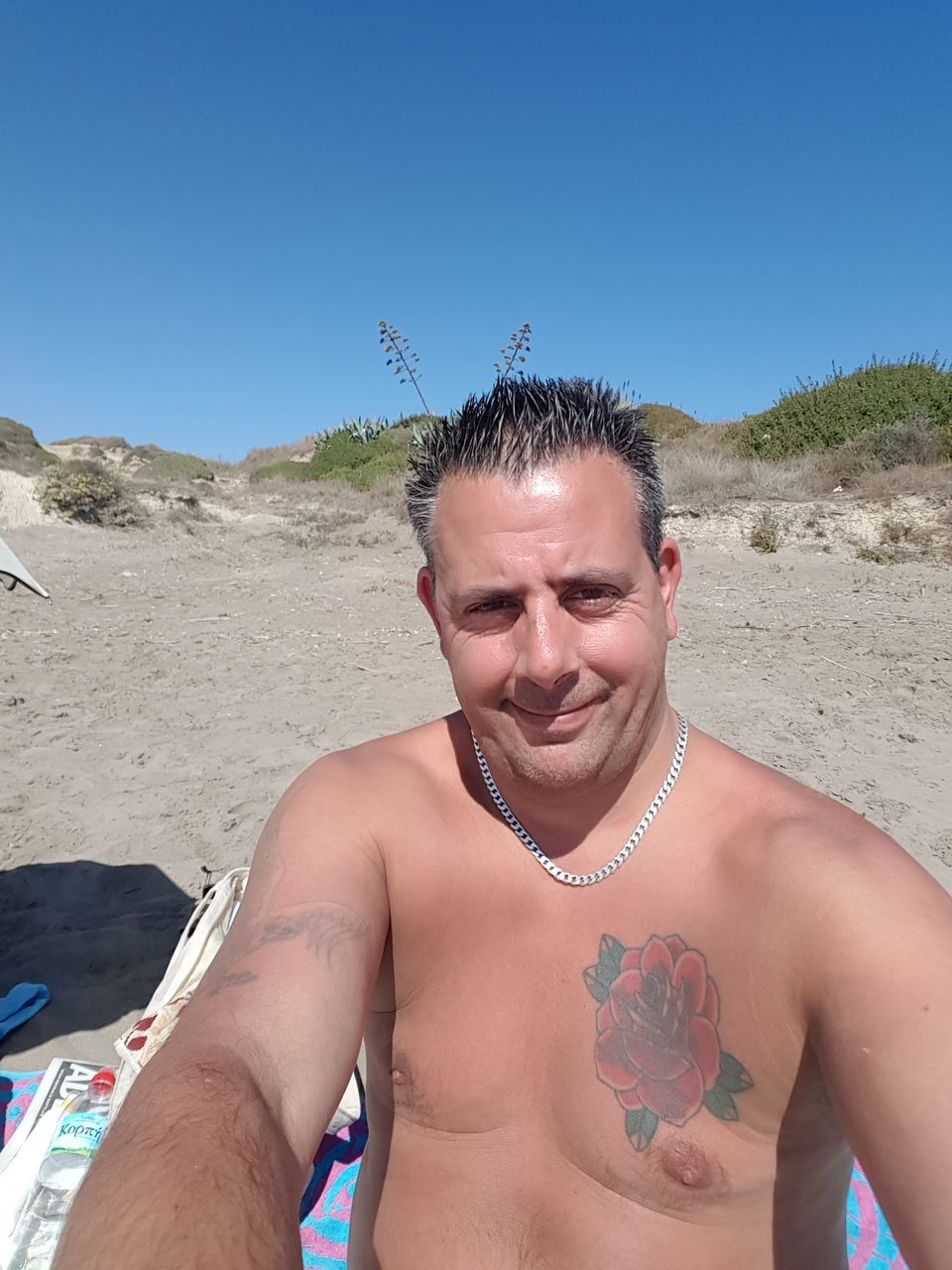 shirtless, sand, real people, beach, one person, vacations, leisure activity, front view, outdoors, day, nature, lifestyles, mature men, looking at camera, young adult, portrait, clear sky, summer, desert, beauty in nature, tree, sand dune, sky, mammal